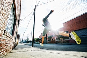 Mixed race athlete jogging on sidewalk