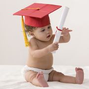 mixed race baby girl wearing mortarboard and holding a diploma
