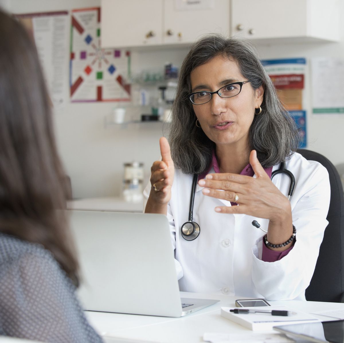mixed race doctor talking to patient
