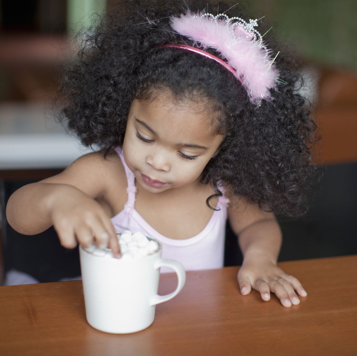 mixed race girl drinking hot chocolate
