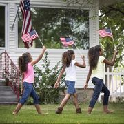 mixed race girls marching with american flags