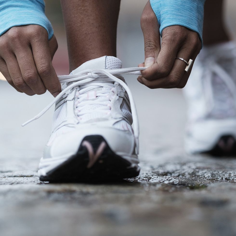 mixed race runner tying shoelaces