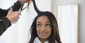 mixed race woman getting hair cut