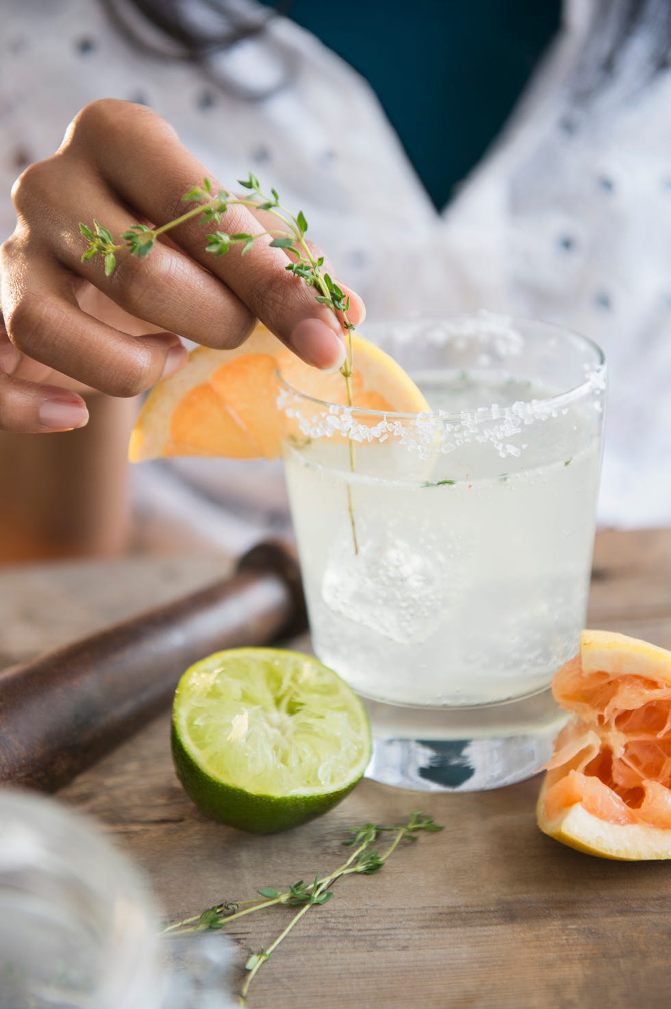 mixed race woman making cocktail