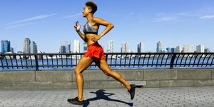 mixed race woman running at waterfront