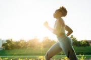 mixed race woman running in park