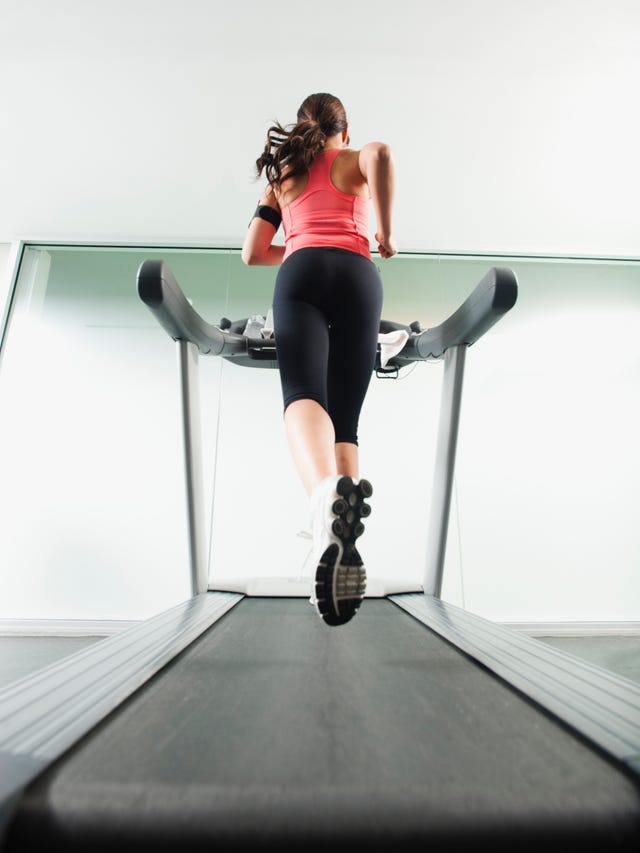 mixed race woman running on treadmill