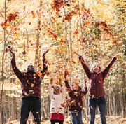 family throwing leaves in the air