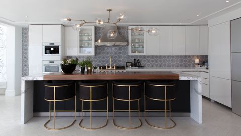 white kitchen with gold and stainless metals