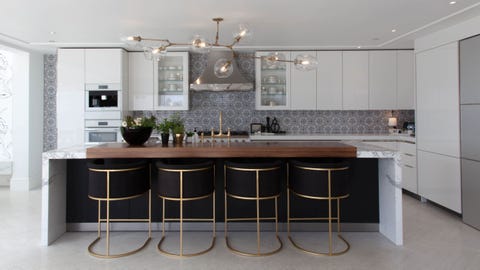 white kitchen with gold and stainless metals