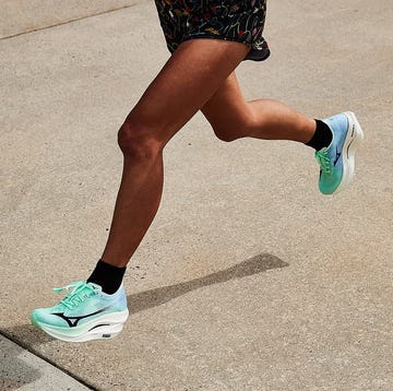 a person's legs running in green running shoes a person's legs running in green running shoes