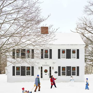 white colonial house in snow