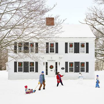 white colonial house in snow