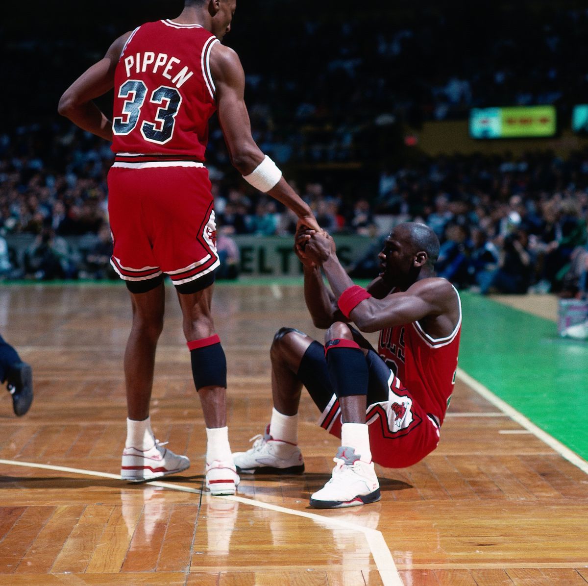 boston   1990  scottie pippen 33 helps michael jordan 23 of the chicago bulls up from the floor against the boston celtics during a game played in 1990 at the boston garden in boston, massachusetts note to user user expressly acknowledges and agrees that, by downloading and or using this photograph, user is consenting to the terms and conditions of the getty images license agreement mandatory copyright notice copyright 1990 nbae photo by dick raphaelnbae via getty images