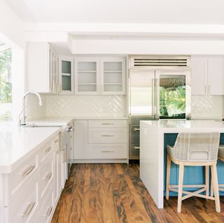 bright white kitchen interior with blue painted center island