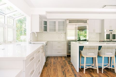 bright white kitchen interior with blue painted center island