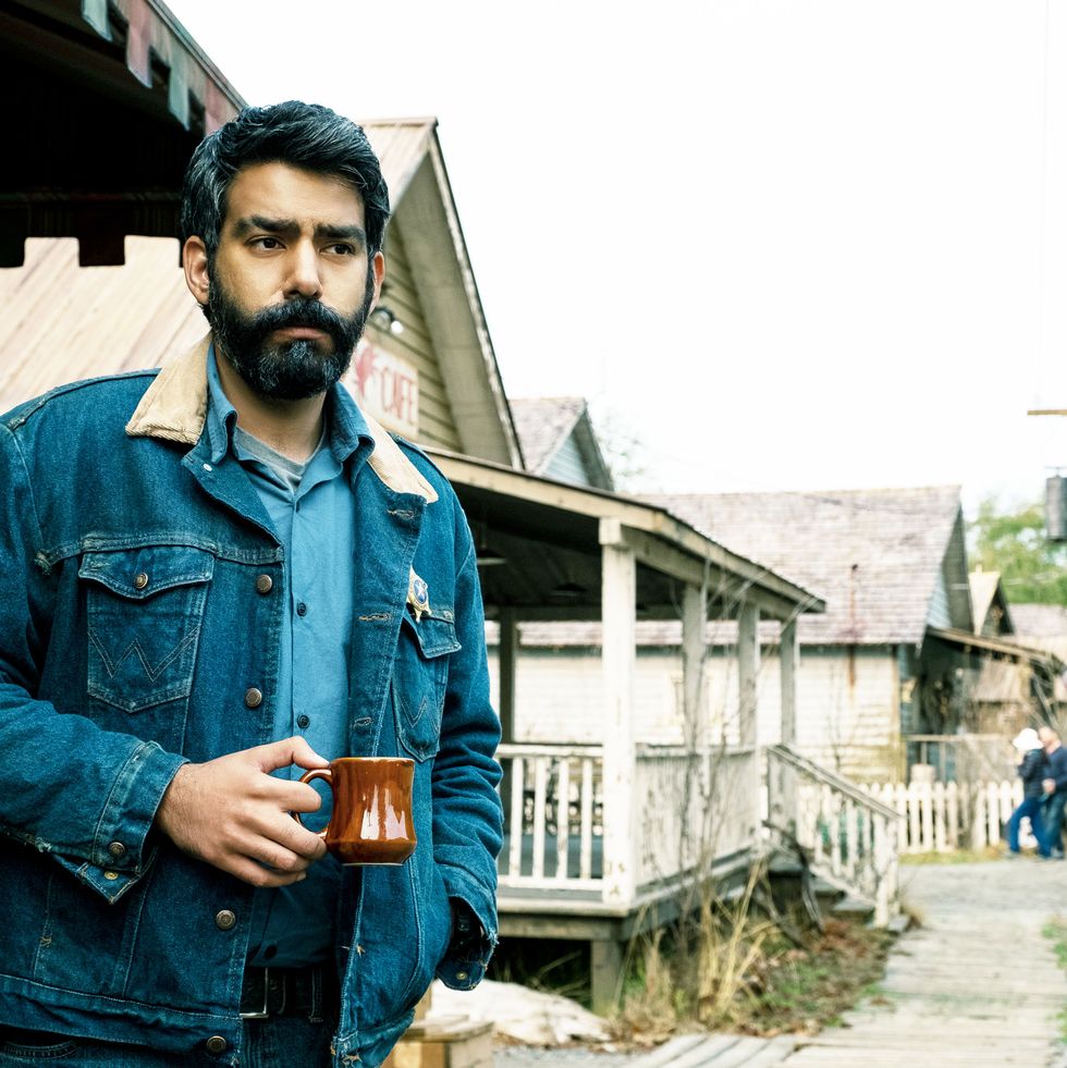 man looking stern holding coffee cup
