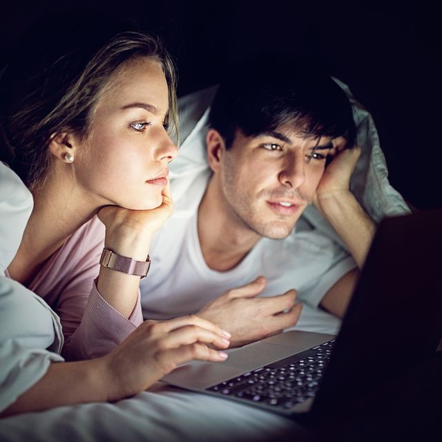 Mobile phone addiction - couple is texting and browsing in the bed