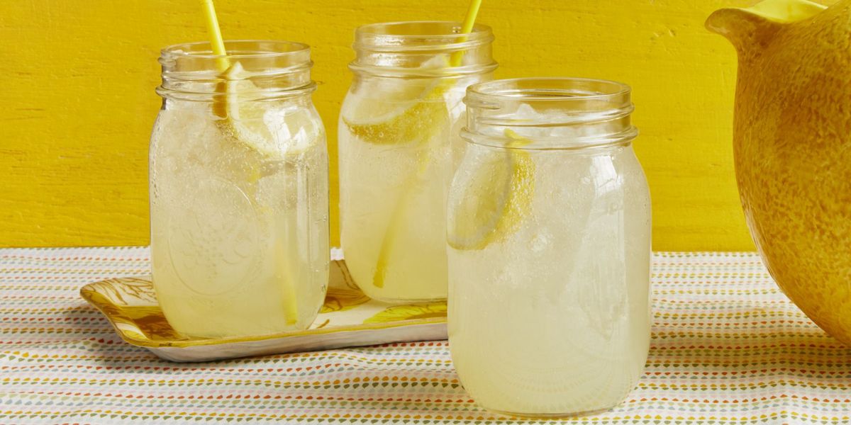 lemonade in jars with straws yellow background