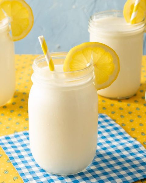 frozen lemonade in jar with straw and lemon slice blue napkin