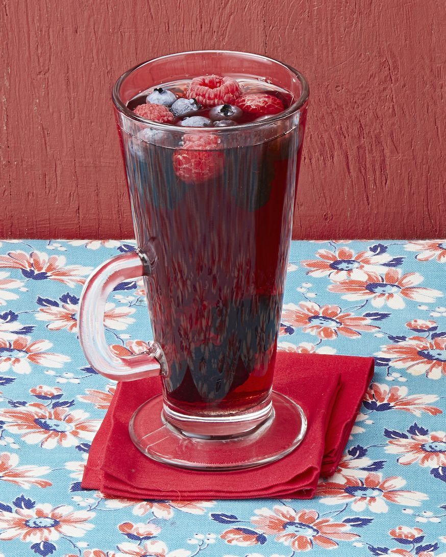 mulled pomegranate cherry juice in tall glass mug