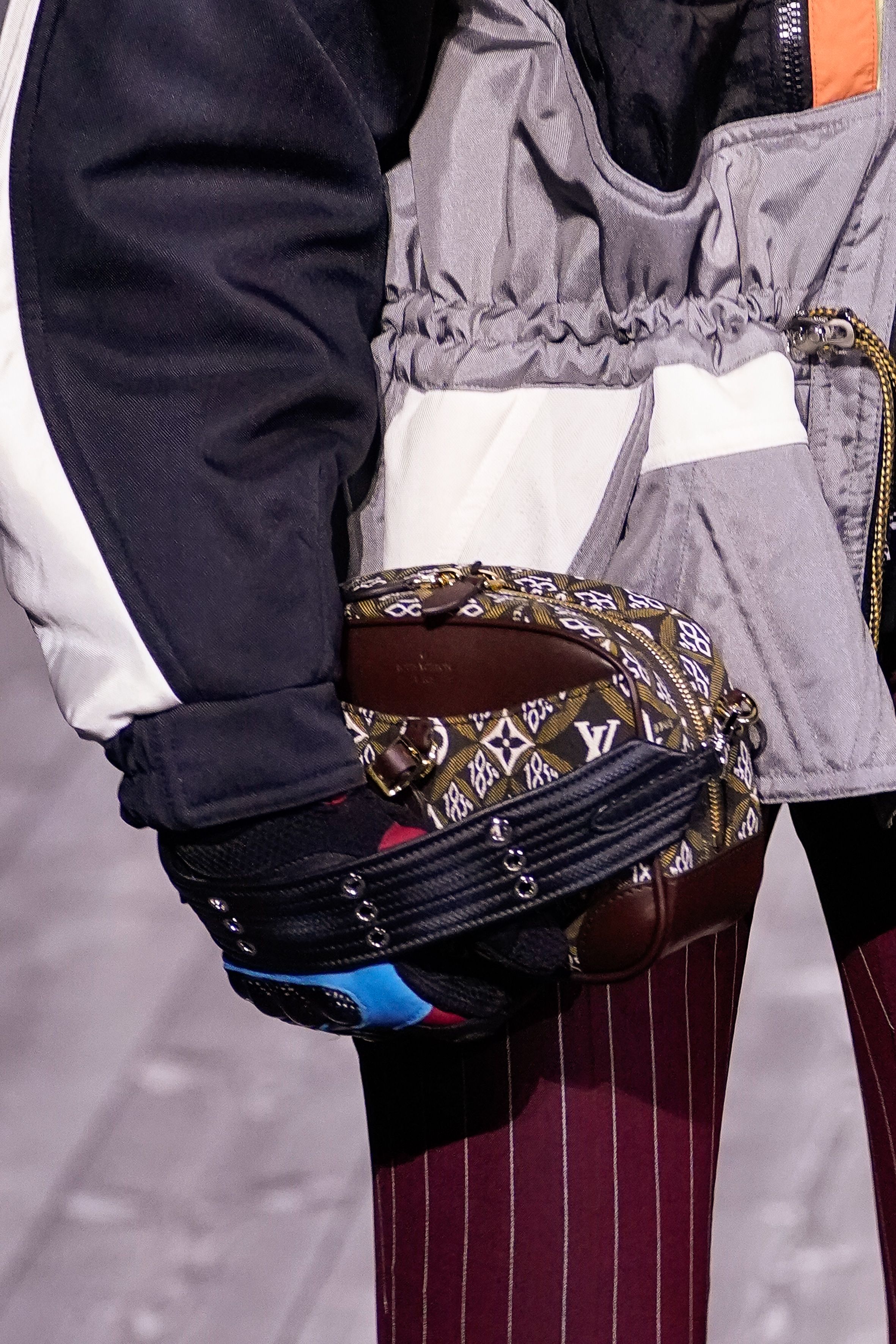 A model, bag detail, walks the runway during the Louis Vuitton