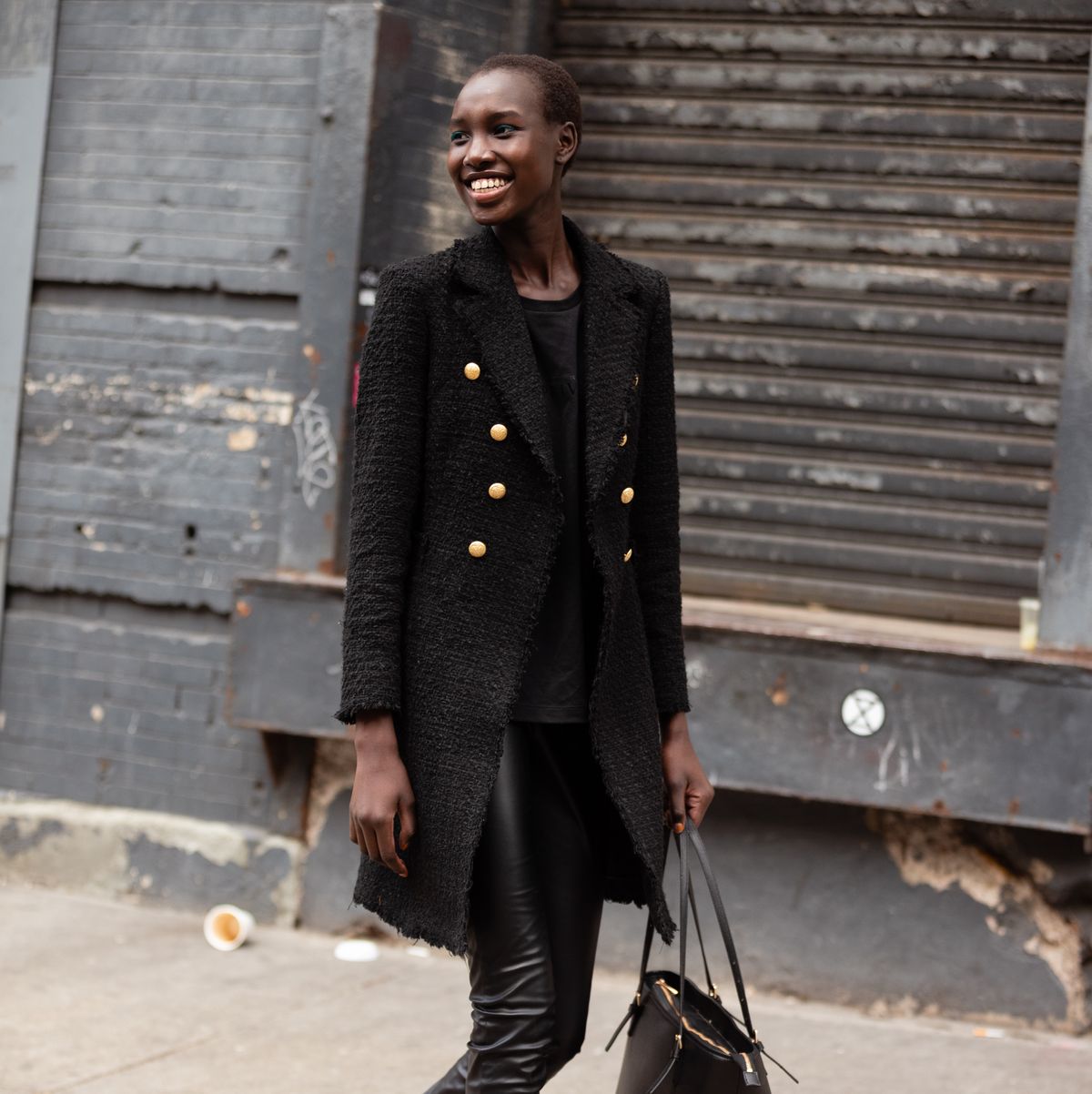 a model wears a peacoat while walking around at new york fashion week