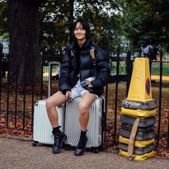 https://hips.hearstapps.com/hmg-prod/images/model-pan-haowen-wears-a-black-puffer-jacket-and-sits-on-news-photo-1693321811.jpg?crop=0.668xw:1.00xh;0.120xw,0&resize=640:*