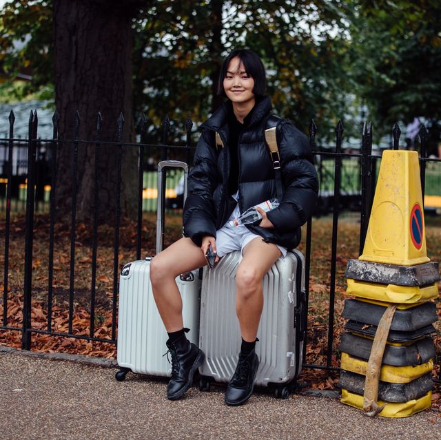 https://hips.hearstapps.com/hmg-prod/images/model-pan-haowen-wears-a-black-puffer-jacket-and-sits-on-news-photo-1693321811.jpg?crop=0.668xw:1.00xh;0.120xw,0&resize=640:*