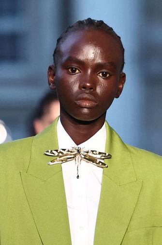 a man wearing a green suit
