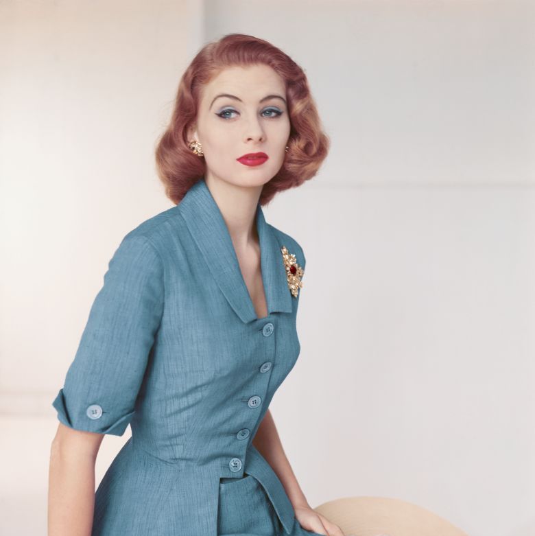 woman in 1950s fashion trends cinched waist peplum