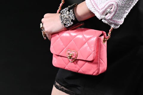 a model carries a pink chanel flap bag at the spring summer 2023 show to illustrate a guide to summer 2023 bag trends