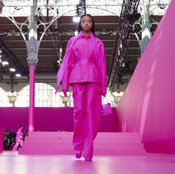 a model walks down the valentino runway wearing a hot pink matching set