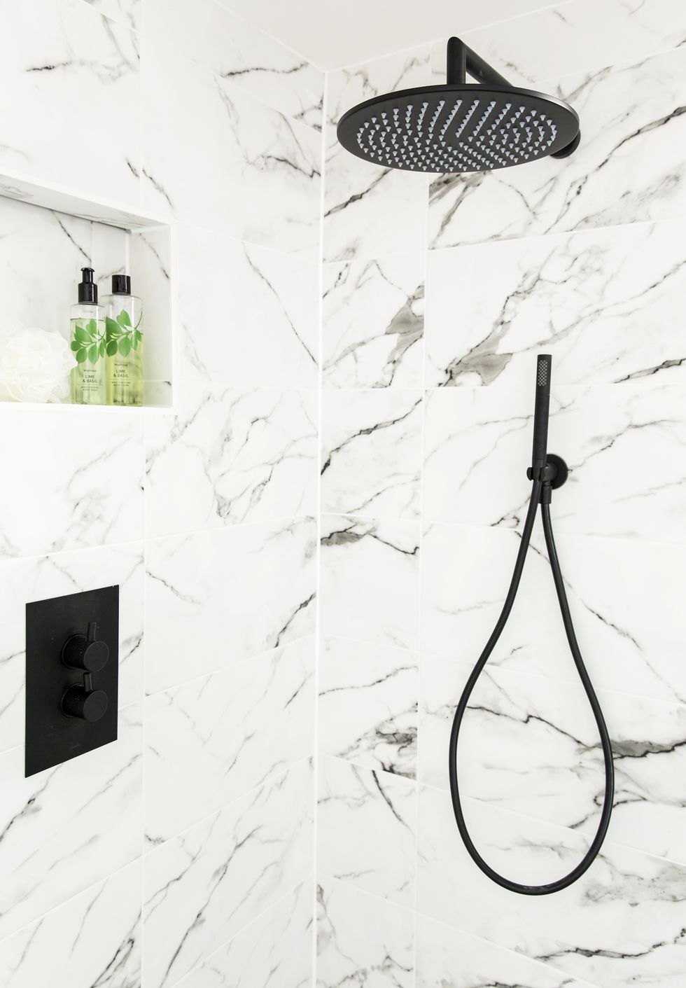 black shower head and fittings on a marble effect tiled wallshowerthe new concealed black shower made use of the existing boxed in pipework for a sleek,streamlined finish