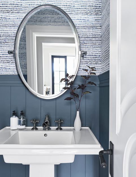 blue and white bathroom with striped wallpaper