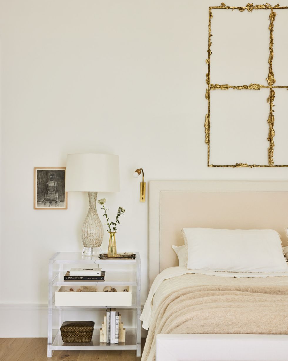 designer kristin fine’s 12 year old modern farmhouse in westport, connecticut primary bedroom bronze sculpture by tania pérez córdova, crowns a the 1818 collective bed in dedar fabric sconce garde drawing merlin james nightstand custom, antony todd lamp vintage murano bedding society limonta linens hermès blanket