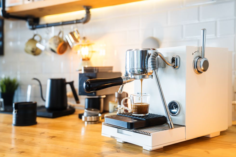 modern espresso machine brewing fresh coffee in cozy kitchen setting