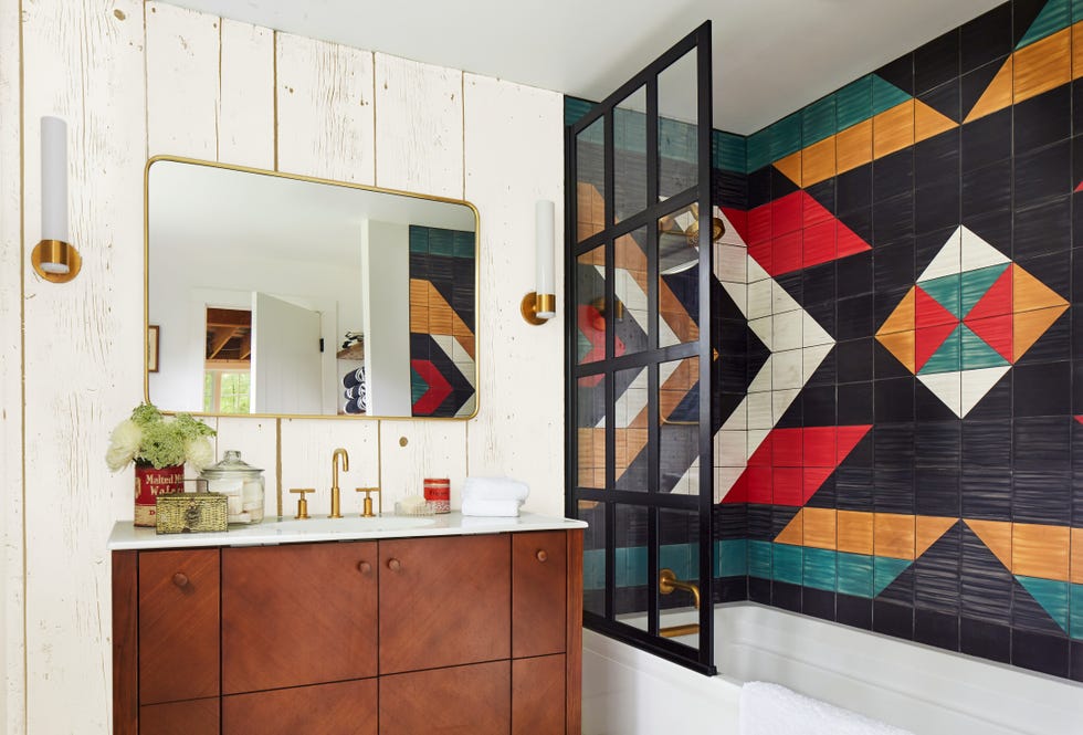 bathroom with a tiled shower wall painted like a pendleton blanket