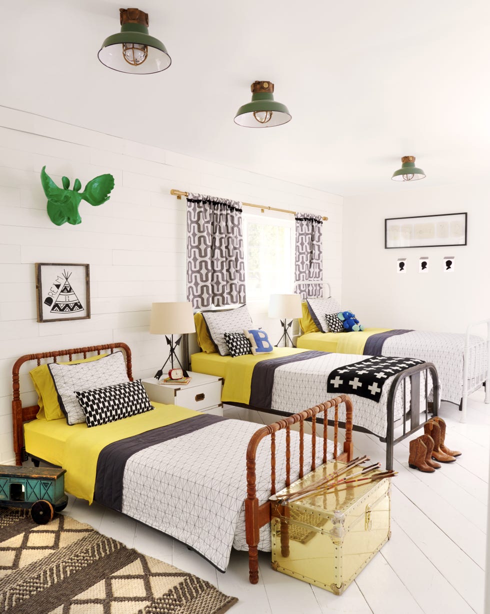 farmhouse kids room with three twin beds with yellow sheets