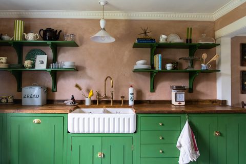 modern kitchen  statement sink with green kitchen cabinets