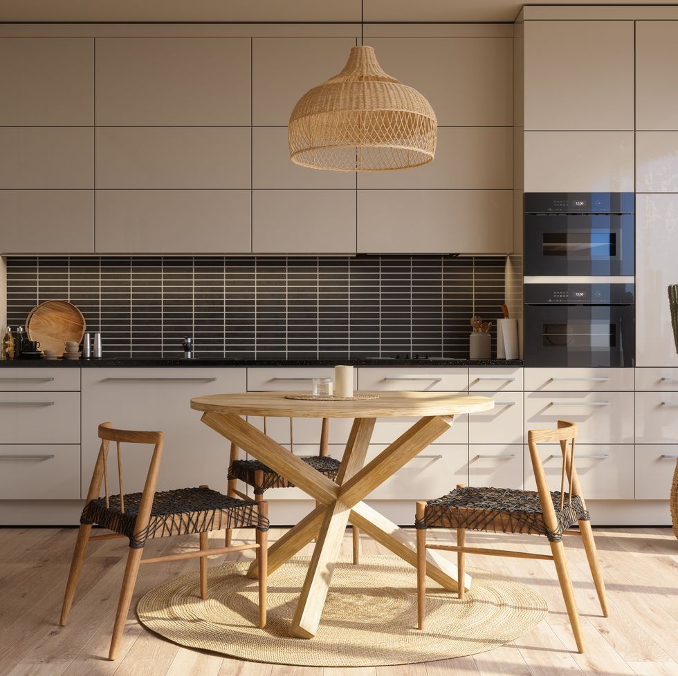 modern kitchen interior with beige cabinets, wood dining table, chairs and cactus plant