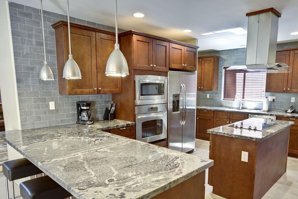 modern kitchen interior with dark units and marble counters