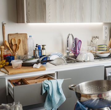 modern kitchen with dirty countertop and full of things to wash up in the sink