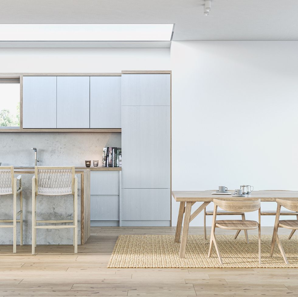 modern light blue kitchen with rectangular marble breakfast kitchen island with stools and dining room