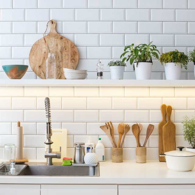 modern new light kitchen interior with utensils, decoration and pots with herbs
