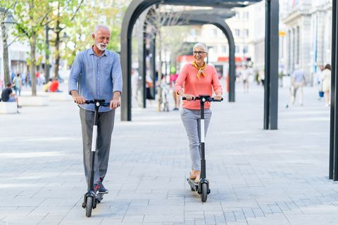 modern senior couple with electric scooter