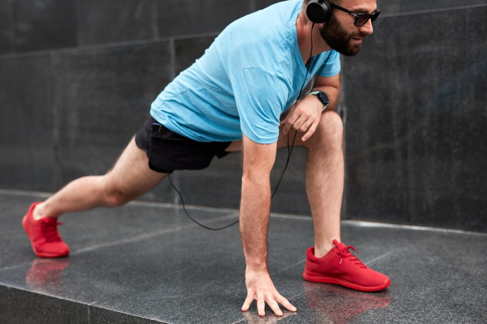 modern sporty man making pause and stretching after jogging  exercise in urban environment