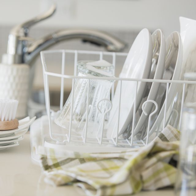 Modern white dishes drying in rack.