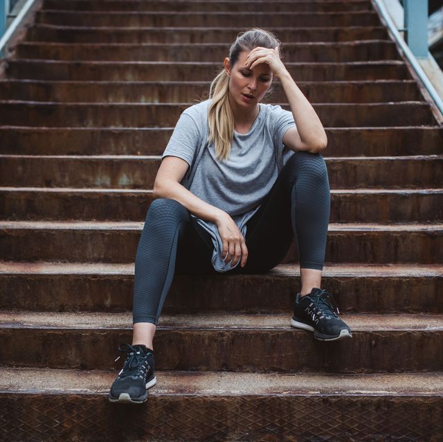 woman resting on the stairs after hard cross training outdoor