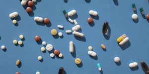 top view of various pills and tablets on the blue background